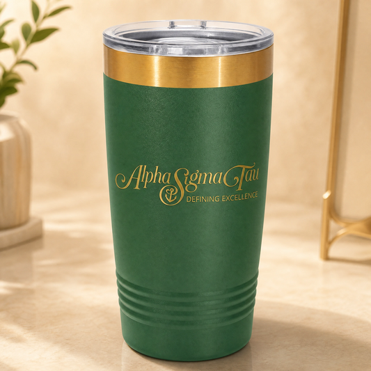 Green tumbler with gold rim and 'Alpha Sigma Tau' logo on a beige surface.
