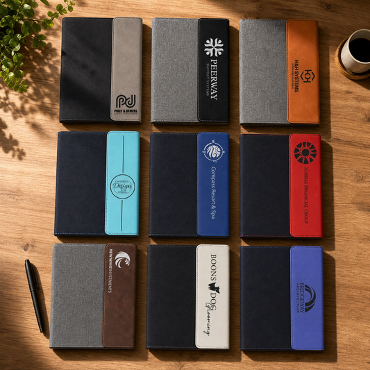 Custom engraved portfolio open on desk with brass pen — personalized executive gift