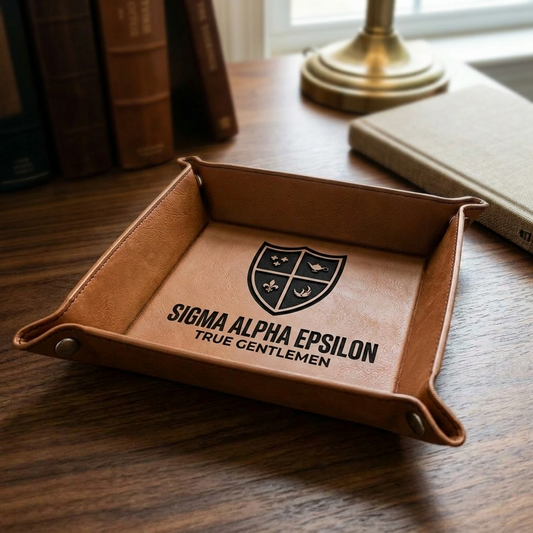 Royal Purple or Tan leatherette catchall tray with gold snaps, featuring a detailed engraving of the Sigma Alpha Epsilon crest and Greek letters in the center.
